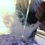 Blowing smoke from a cigar into the mixture